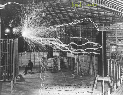 Probably the most famous photograph of Tesla, a double exposure with him seated below massive streamers.